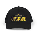Black I AM THE UPGRADE snapback trucker hat featuring gold embroidered text.