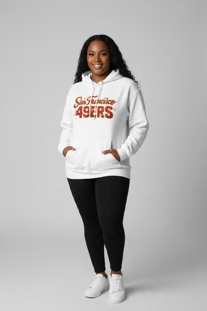 A woman wearing a white Throw it in the Bag San Francisco 49ers fleece hoodie with red script logo and kangaroo pocket