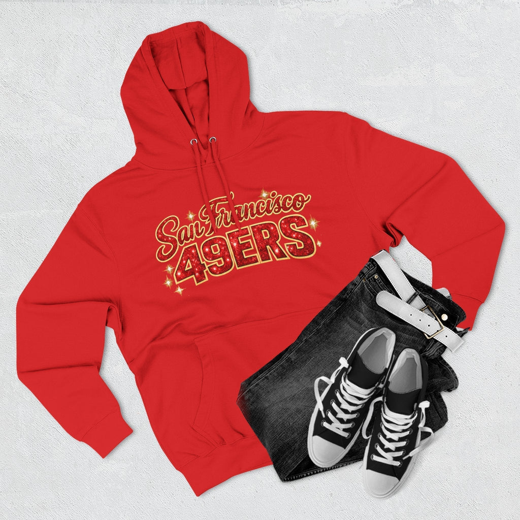 Throw it in the Bag San Francisco 49ers red fleece hoodie with gold script logo, paired with black jeans and sneakers.